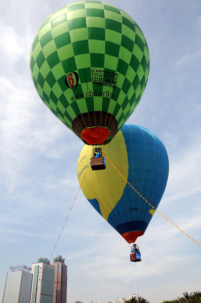 Hot air balloons color S China city sky