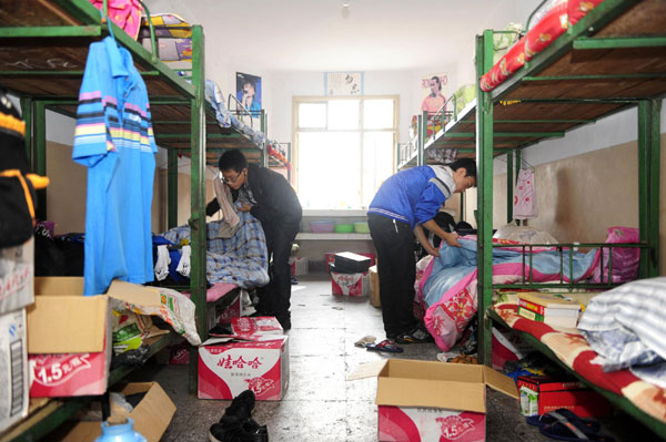 Students pack their luggage in the dormitory of the old school site, ready to move to the newly built Badong No 1 Senior Middle School in Xinling town, Badong county, Central China’s Hubei province, Sept 8, 2011 Students move to new school for safety reasons