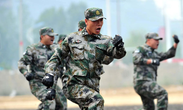 Soldiers display their combat skills during an anti-terrorism drill in Zunyi, Sept 26, 2011. Air-raid, anti-terror drill staged in SW China