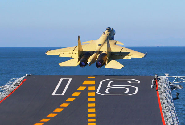 China conducts flight landing on aircraft carrier