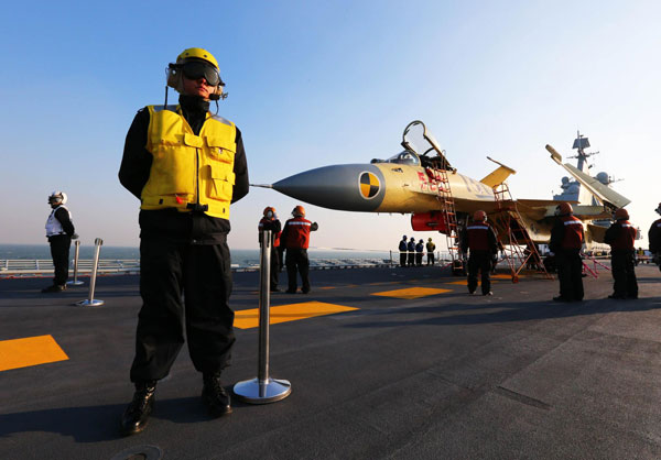 China conducts flight landing on aircraft carrier