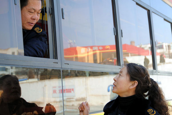 Deputy to the National People's Congress Zhang Huiping talks to bus drivers in Baiyin city, Gansu province on Feb 22. Deputy to be voice of bus drivers, passengers