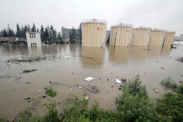 Rainstorms flood five hazardous chemical storage tanks at a petrochemical company in Dongshi town in Jinjiang, in East China’s Fujian province, on May 16, 2013. Rainstorm floods chemical storage tanks
