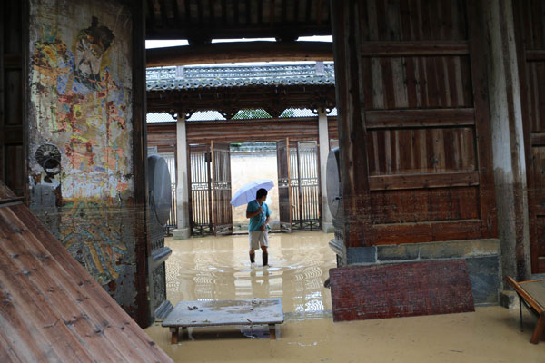 An ancestral hall is flooded after heavy rain hits Chenkan village, Huangshan city, June 30, 2013. Rain-triggered floods kill 4 in E China