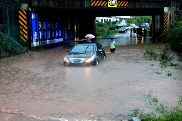 A submerged car during floods in Shexian county, Huangshan city, June 30, 2013. Rain-triggered floods kill 4 in E China