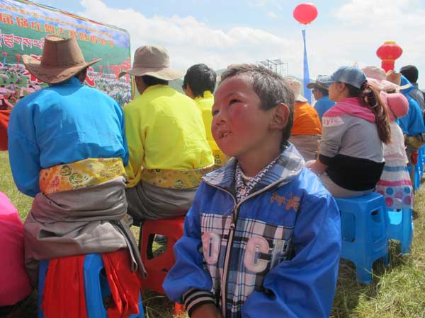 A boy is distracted from the main show during the opening ceremony of the Second Luqu Guozhuang Dance Contest A waltz of joy as dance festival steps into town