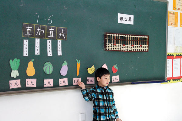 Tian Xingjian, 5, calculates on the abacus on the blackboard at the preschool attached to the Beijing Bright Horizon International Academy primary school. Xu Lin / China Daily Culture that counts