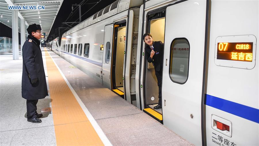 Young couple as railway workers busy for Spring Festival travel rush