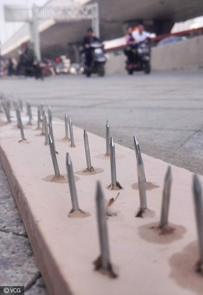 Nail planks placed at street to stop wrongly parked cars