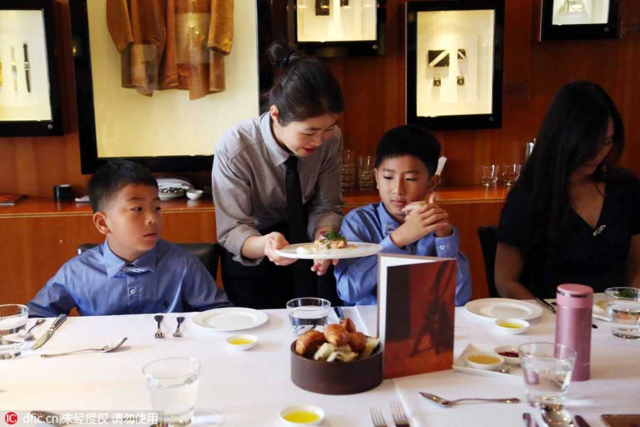 Chinese children paying money to learn British manners