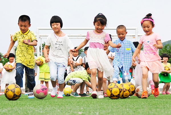 Kicking the ball: Kindergarten children play soccer