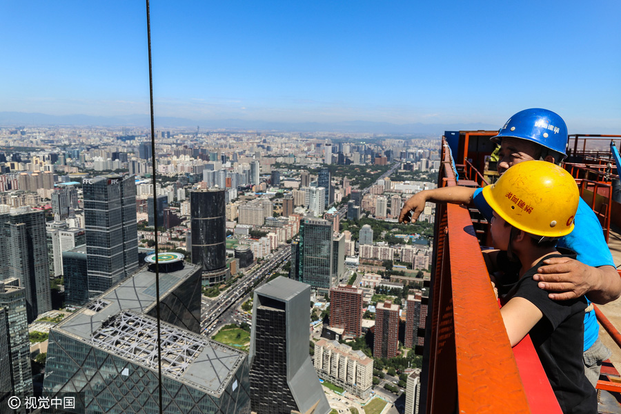 Workers behind Beijing's tallest building