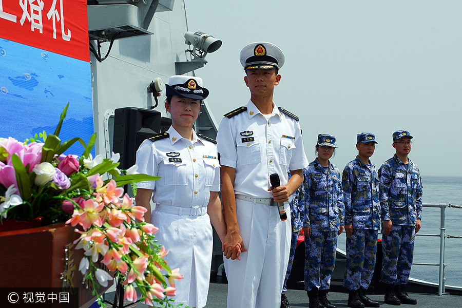 Navy sailors tie knot in middle of sea