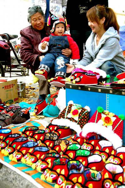 Traditional hand-made boots and hats with tiger images