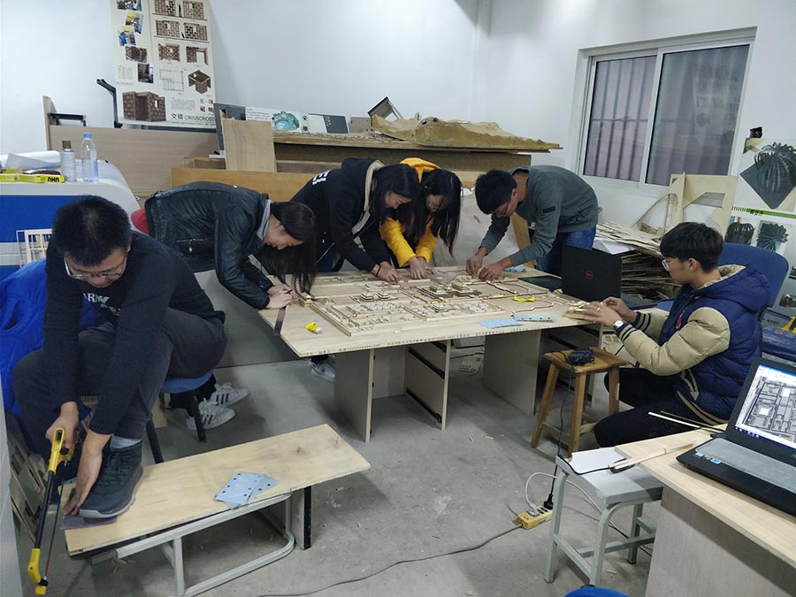 College students miniature Palace Museum on a wooden board