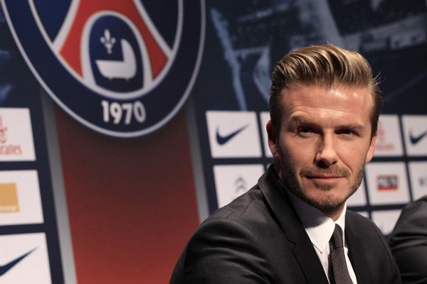 David Beckham arrives for a news conference in Paris