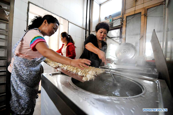 Residents cook dumplings for flood relief workers in Heilongjiang