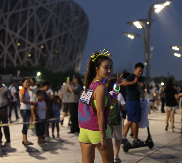 Runners sprint past Beijing's iconic structures