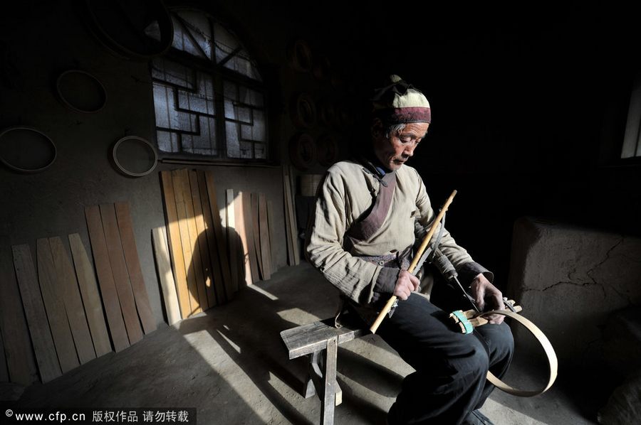 Chen Jianhua, a craftsman, makes a flour sifter at his shop in China West Film Studio, Ningxia Hui autonomous region, on March 16, 2012. Making flour sifter now a craft of the past