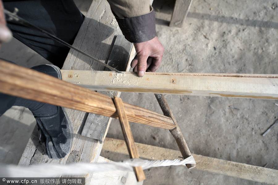 Chen Jianhua, a craftsman, makes a flour sifter at his shop in China West Film Studio, Ningxia Hui autonomous region, on March 16, 2012. Making flour sifter now a craft of the past