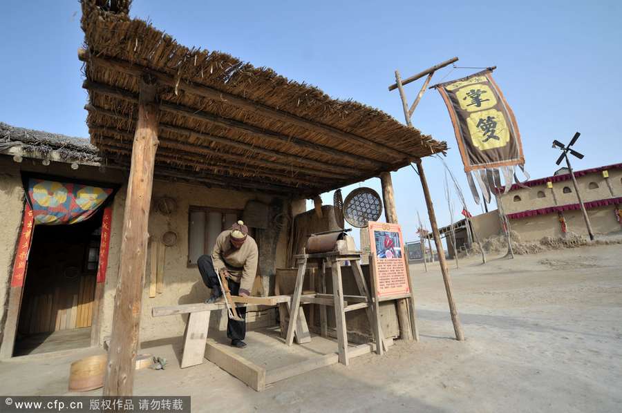 Chen Jianhua, a craftsman, makes a flour sifter at his shop in China West Film Studio, Ningxia Hui autonomous region, on March 16, 2012. Making flour sifter now a craft of the past