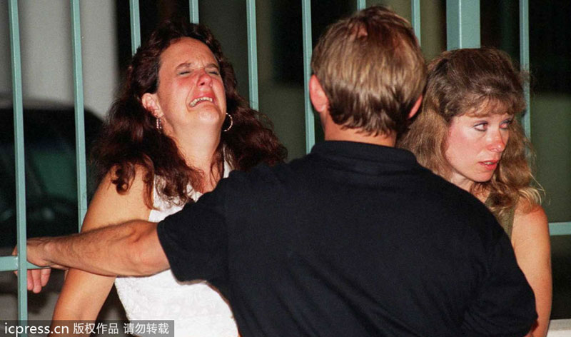 This file photo dated July 27, 1996 shows a woman crying after an explosion rocked Centennial Park in Atlanta. Attacks and threats affected sporting events in history