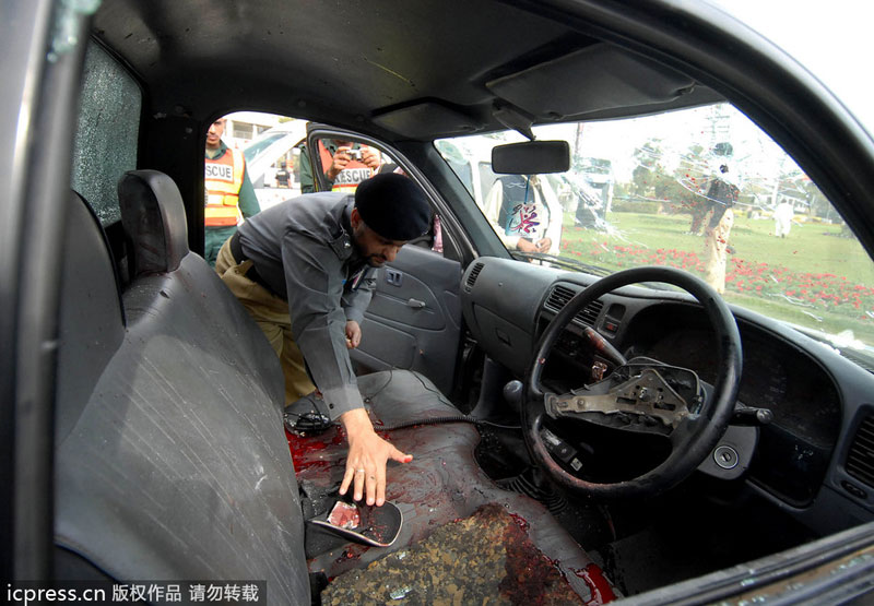 A Pakistani policeman inspects a police vehicle after masked gunmen attacked the Sri Lankan cricket team in Lahore, on March 3, 2009. Attacks and threats affected sporting events in history