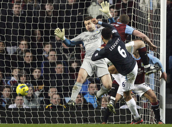 Joleon Lescott's 62nd-minute goal and a brilliant late save by goalkeeper Joe Hart sent Manchester City back to the top of the Premier League with a tense 1-0 win at Aston Villa on Sunday. Streaker invades as Man City back to the top
