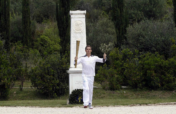 London Olympics flame lit in Olympia, torch relay begins