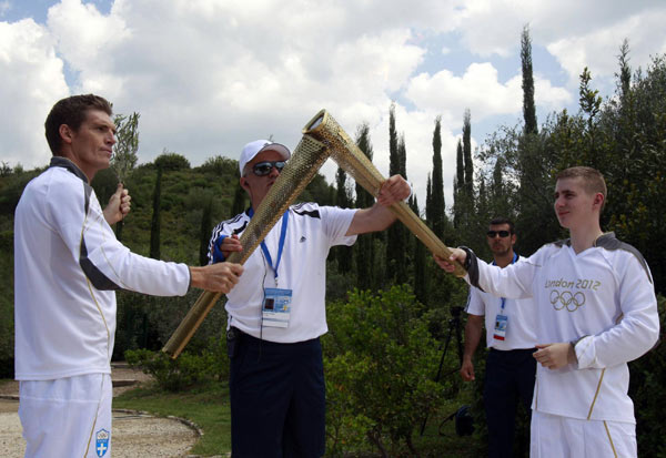 London Olympics flame lit in Olympia, torch relay begins