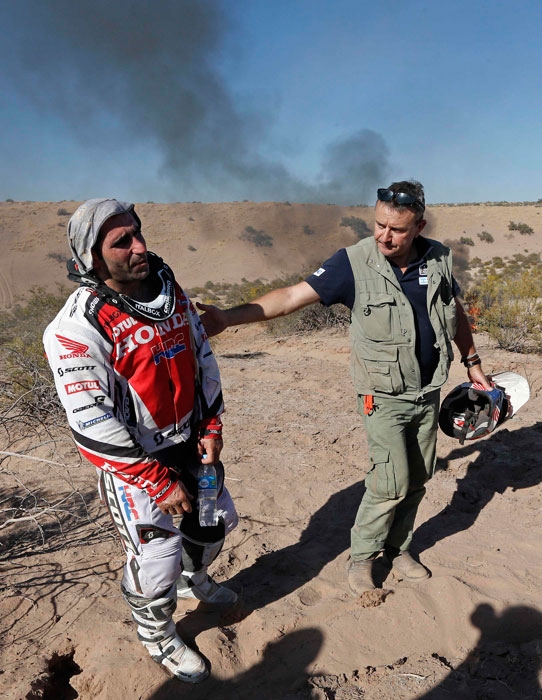 Paulo Goncalves' bike in flames in the Dakar Rally