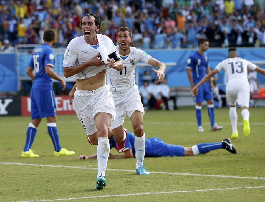 Suarez storm as Godin header sends Uruguay through