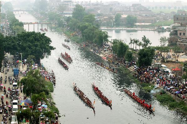 Participants compete in dragon boat races before Dragon Boat Festival