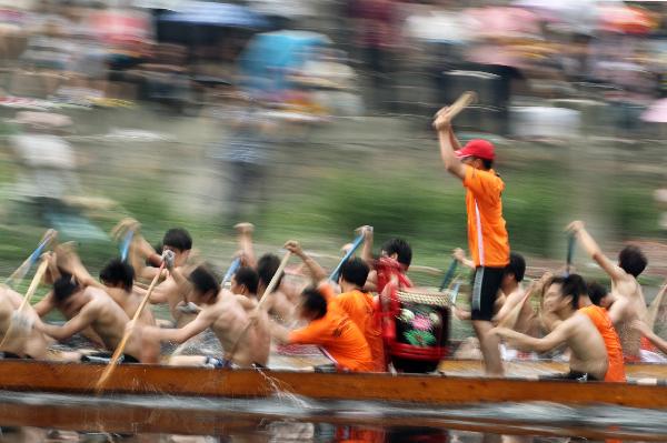 Participants compete in dragon boat races before Dragon Boat Festival