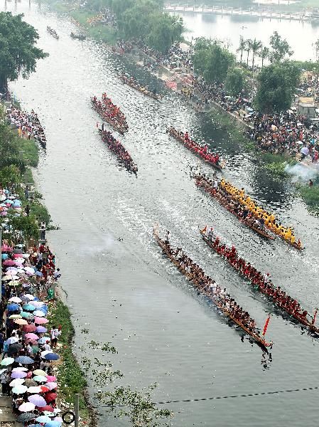 Participants compete in dragon boat races before Dragon Boat Festival