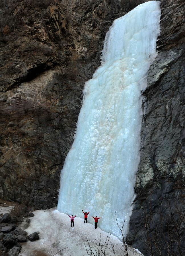 Tourists do ice climbing on frozen waterfall in suburb of Beijing