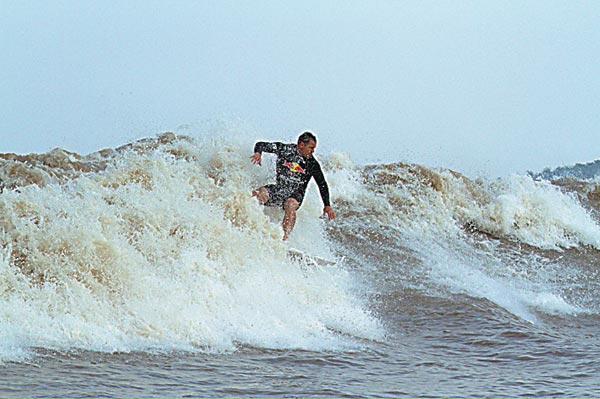 Surfers drop in on Qiantang's Silver Dragon