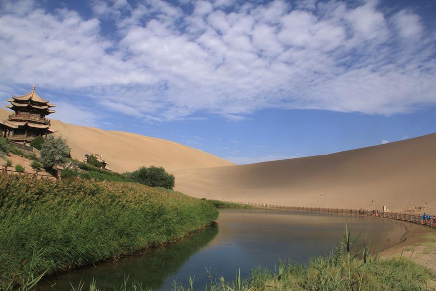 Tourists visit Mingsha Mountain in Dunhuang