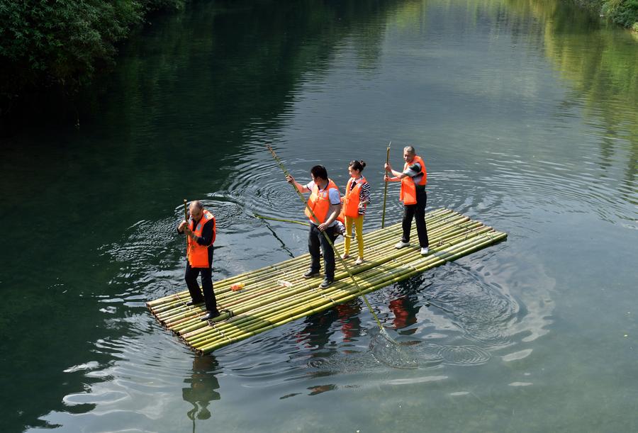 Tourists enjoy bamboo rafting in China's Hubei