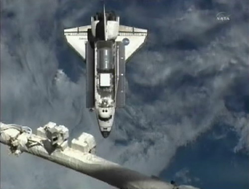 Discovery docks at space station on final voyage