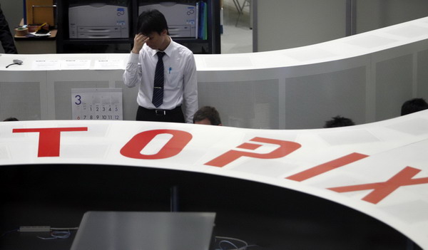 Japan feeds more money to banks as stocks slump