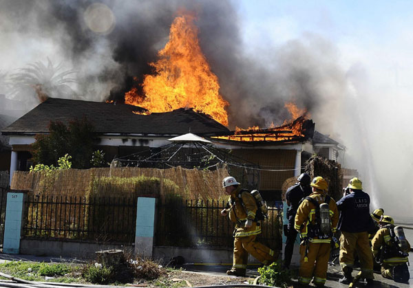 Los Angeles firefighters battle a house fire