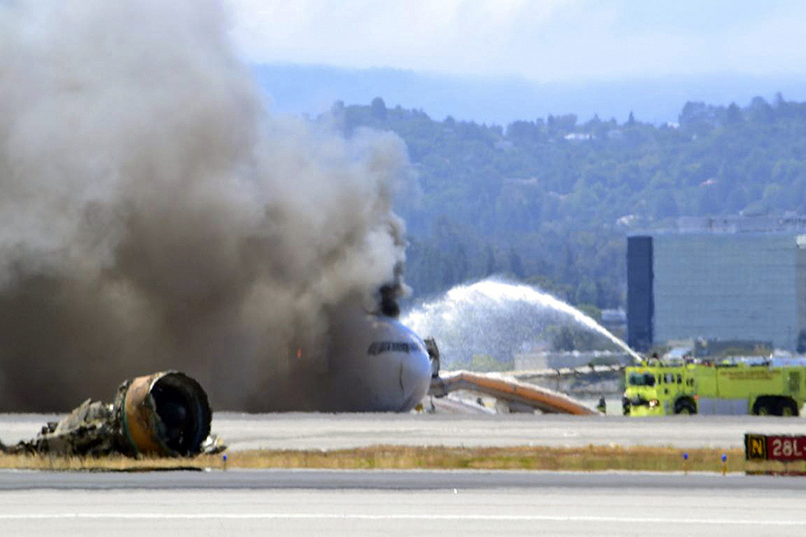 Firefighters spray water on Asiana Airlines flight 214 as it sits on the runway, burning at San Francisco International Airport (SFO) on July 6, 2013. The plane, with 307 people on board, crashed and burst into flames as it landed at San Francisco International Airport on Saturday after a flight from Seoul, and initial reports said two people were killed and more than 130 sent to hospitals. A total of 69 people were still unaccounted for, as officials tracked down the passengers in the confusion after the crash. Asiana flight crashed at SFO