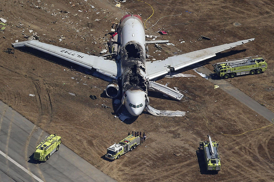 Firefighters surround an Asiana Airlines Boeing 777 plane after it crashed while landing at San Francisco International Airport in California on July 6, 2013. Two people were killed and 130 were hospitalized after the plane crash-landed at San Francisco International Airport on Saturday morning, San Francisco Fire Department Chief Joanna Hayes-White said. The figures cited by Hayes-White leave 69 people still unaccounted for in the accident. The Boeing 777, which had flown from Seoul, South Korea, was carrying 307 people. Asiana flight crashed at SFO