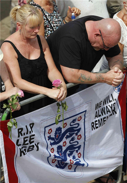 Mourners listen to the funeral service of Fusilier Lee Rigby at the parish church in Bury, northern England July 12, 2013. UK murdered soldier buried