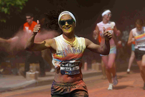 A runner is sprayed with paint powder during The Color Run outside Wembley Stadium in London, July 14, 2013. The Color Run is a five kilometre, un-timed race, held in cities across the US and also worldwide, with the aim of promoting healthy living, and the organizers choose a charity to benefit in each of the cities the run visits. Participants are doused from head to toe in different colours at each kilometre. Color Run in London promotes healthy living
