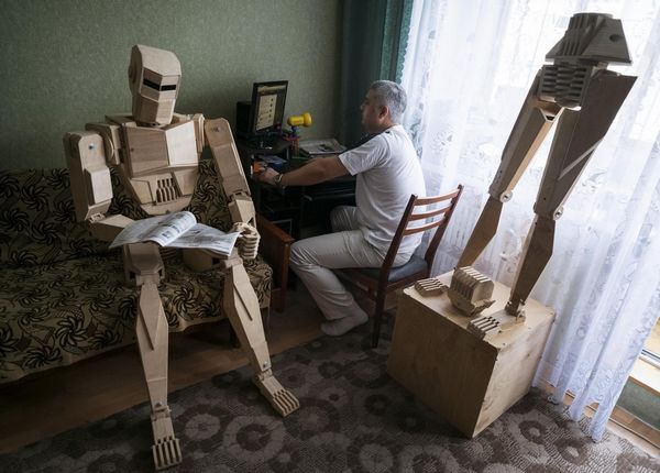 Crane operator creates wooden robot