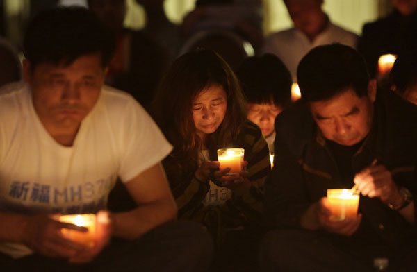 Candlelight prayers offered for missing 239