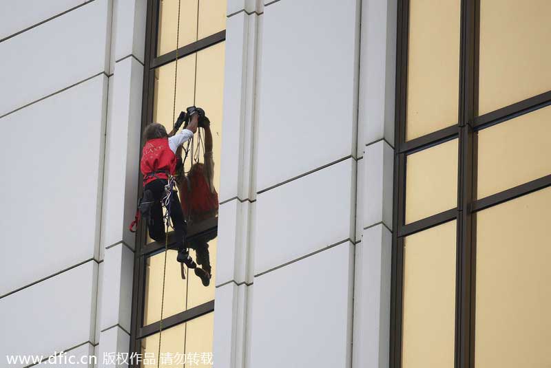 French 'spiderman' scales 33-story building in Macao