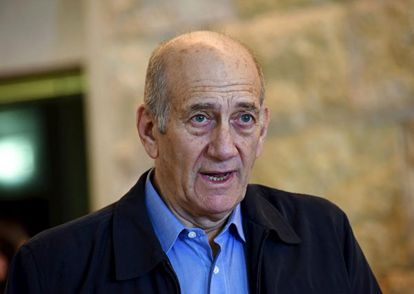 Former Israeli PM Olmert's jail term cut, cleared of main charge